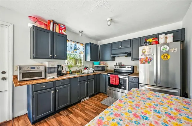 a kitchen with granite countertop stainless steel appliances a sink and counter space