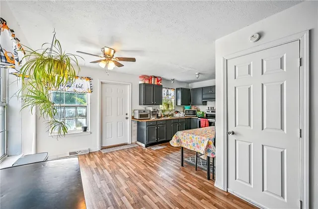 a kitchen view with wooden floor and window