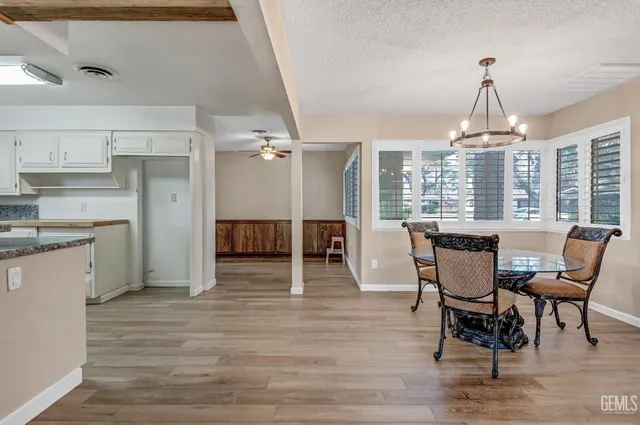 a kitchen with a stove a sink and wooden floor