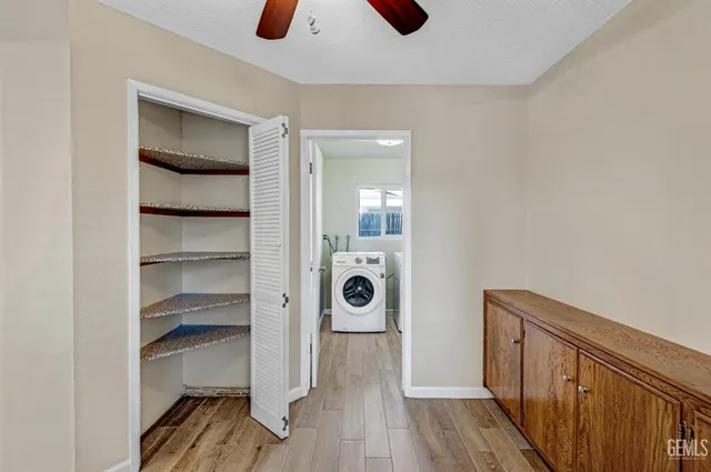 a view of workspace with wooden floor and fan