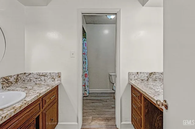 a bathroom with a granite countertop sink and a mirror