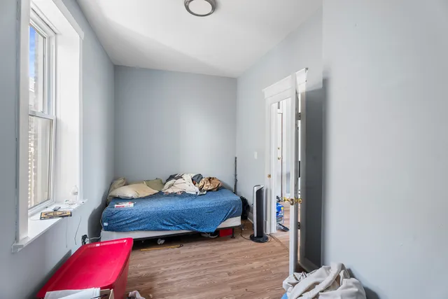 a bedroom with a bed and a window