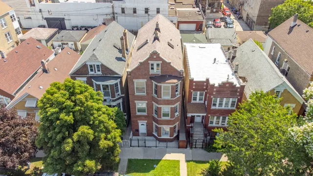 an aerial view of multiple houses with yard