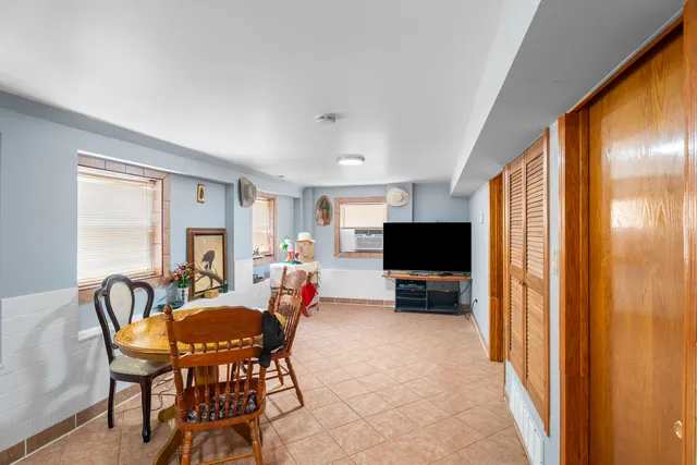 a kitchen with stainless steel appliances granite countertop a stove top oven a sink dishwasher and a refrigerator with wooden floor