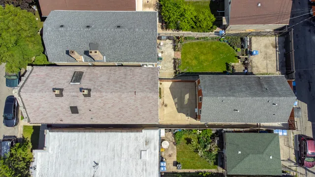 an aerial view of a house with a yard