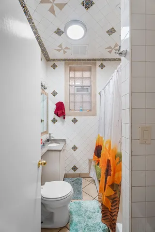 a bathroom with a toilet sink and mirror