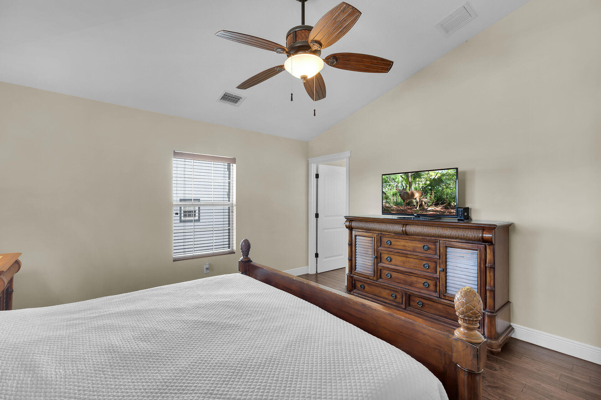 27415 Barbuda Lane Summerland Key, FL 33042 - Photo 28 of 43 a bedroom with a bed and a chandelier