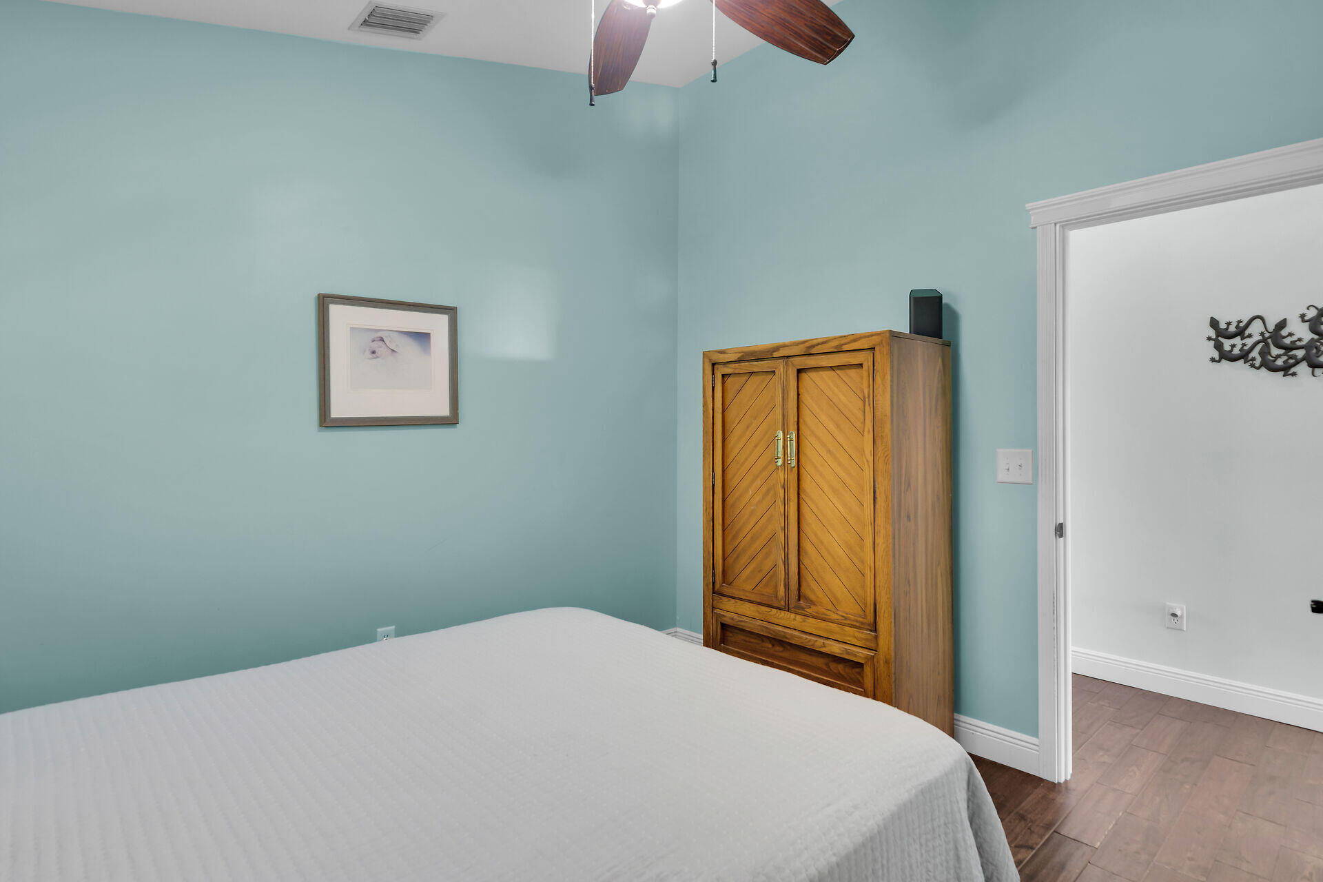 27415 Barbuda Lane Summerland Key, FL 33042 - Photo 40 of 43 a bedroom with a bed and a chandelier