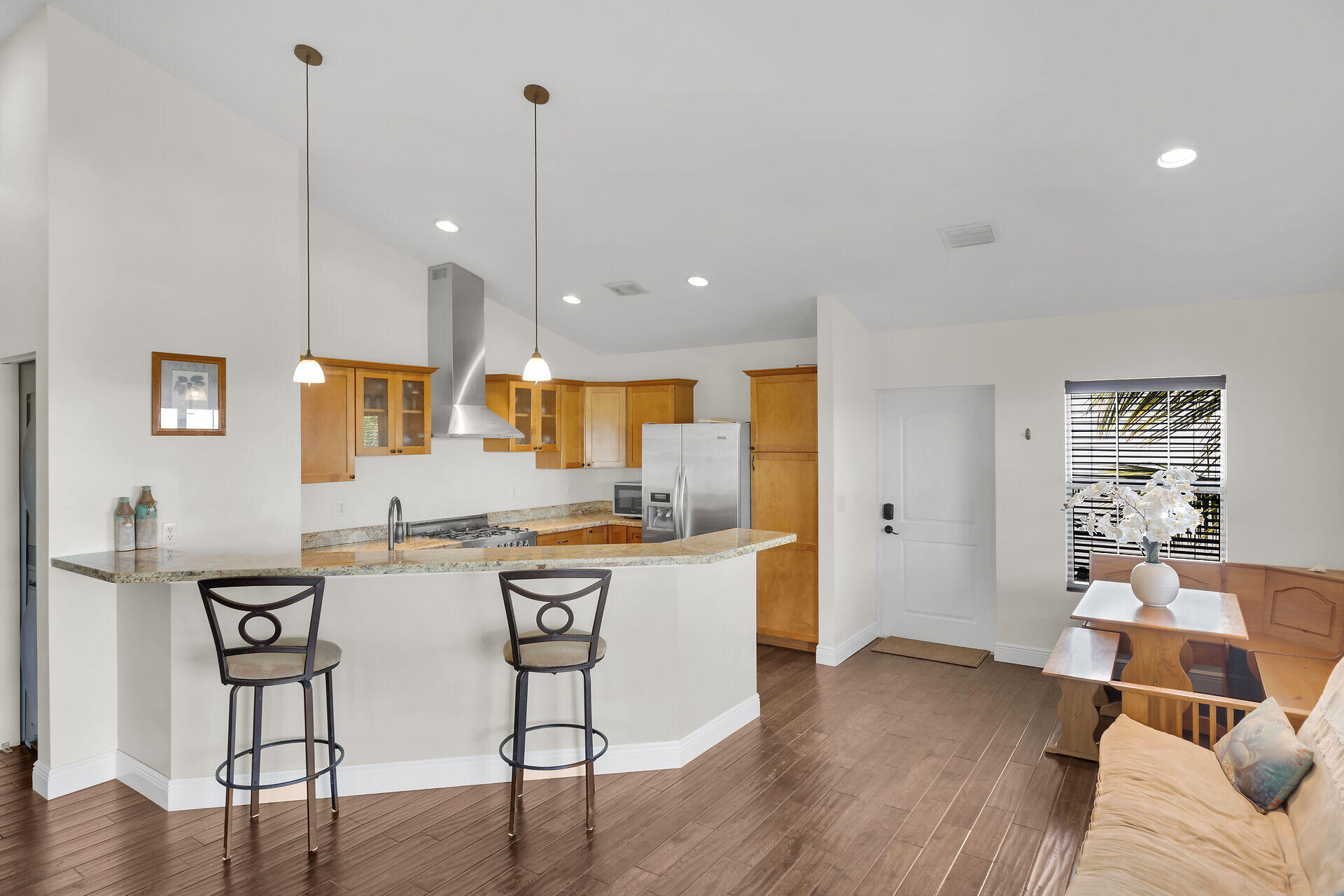 27415 Barbuda Lane Summerland Key, FL 33042 - Photo 8 of 43 a kitchen with stainless steel appliances granite countertop a sink a stove a refrigerator and island with wooden floor
