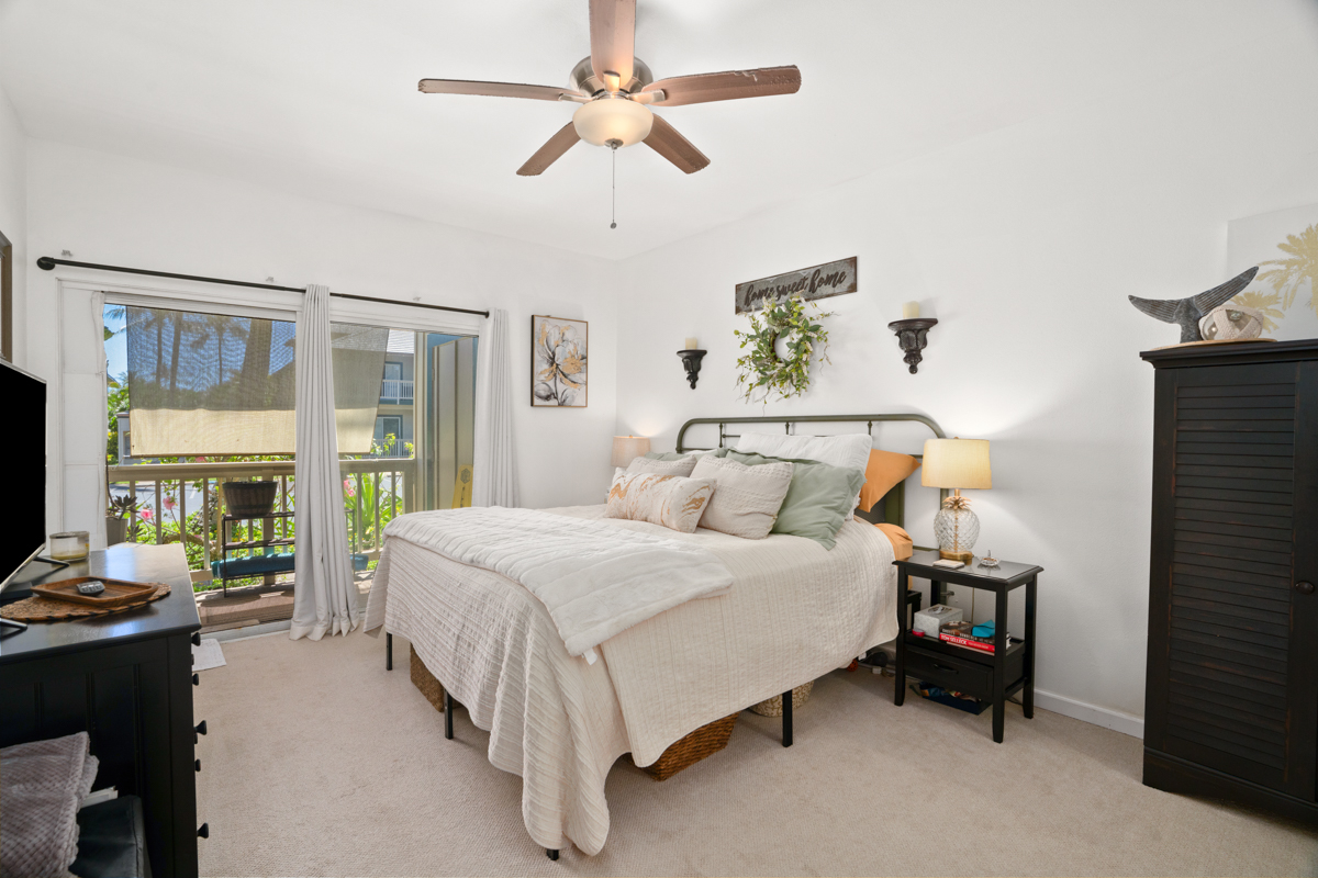 1831 Poipu Road, Unit 113 Koloa, HI 96756 - Photo 11 of 22 a bedroom with a bed and a chandelier