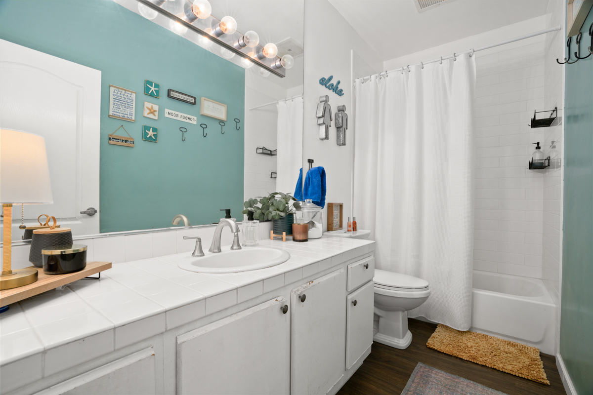 1831 Poipu Road, Unit 113 Koloa, HI 96756 - Photo 15 of 22 a bathroom with double vanity sink a mirror and a shower