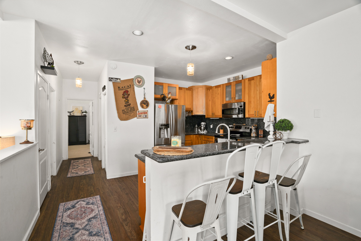 1831 Poipu Road, Unit 113 Koloa, HI 96756 - Photo 7 of 22 a kitchen with stainless steel appliances a sink stove and refrigerator