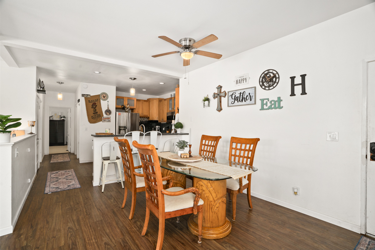 1831 Poipu Road, Unit 113 Koloa, HI 96756 - Photo 9 of 22 a view of a dining room with furniture and wooden floor