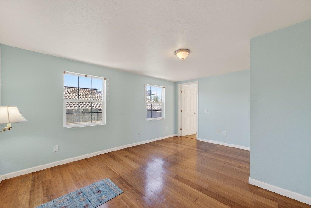 107 Behler Road Watsonville, CA 95076 - Photo 19 of 43 an empty room with wooden floor and windows