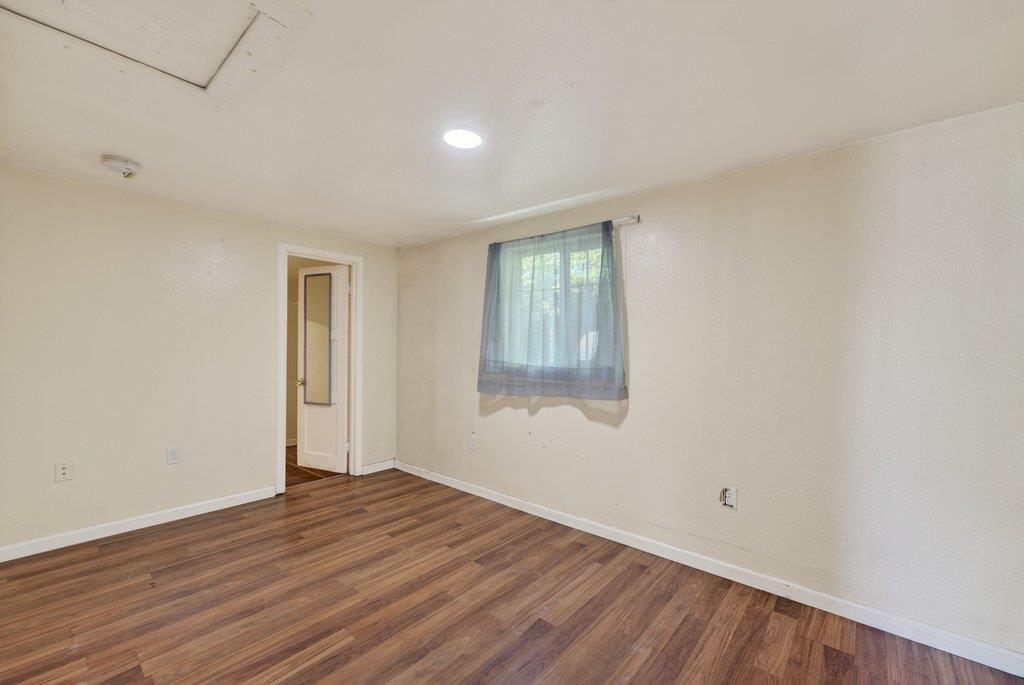 107 Behler Road Watsonville, CA 95076 - Photo 30 of 43 a view of an empty room with wooden floor and a window