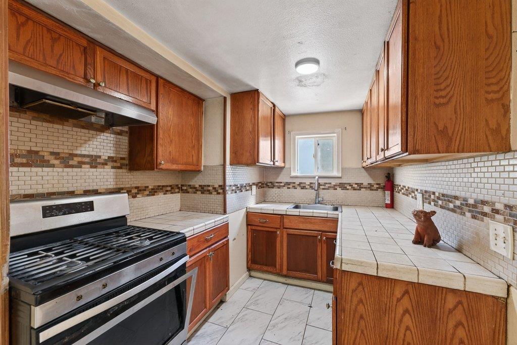 107 Behler Road Watsonville, CA 95076 - Photo 34 of 43 a kitchen with a sink stove top oven and cabinets