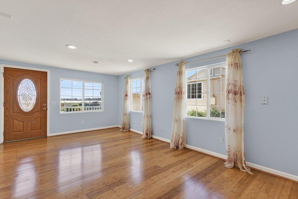 107 Behler Road Watsonville, CA 95076 - Photo 4 of 43 an empty room with wooden floor and windows