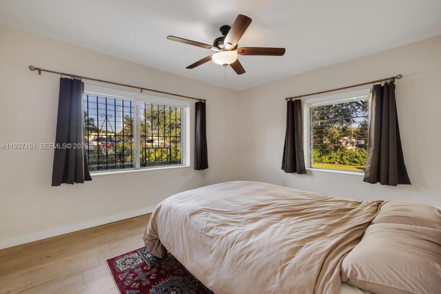 424 Northwest 53rd Street Miami, FL 33127 - Photo 11 of 20 a bedroom with a bed and a large window