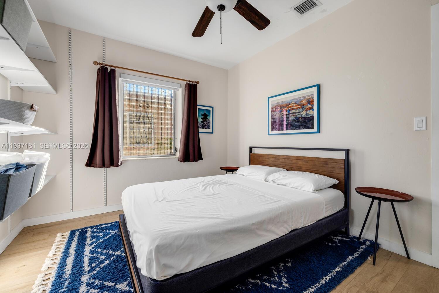 424 Northwest 53rd Street Miami, FL 33127 - Photo 15 of 20 a bedroom with a bed a dresser and a window