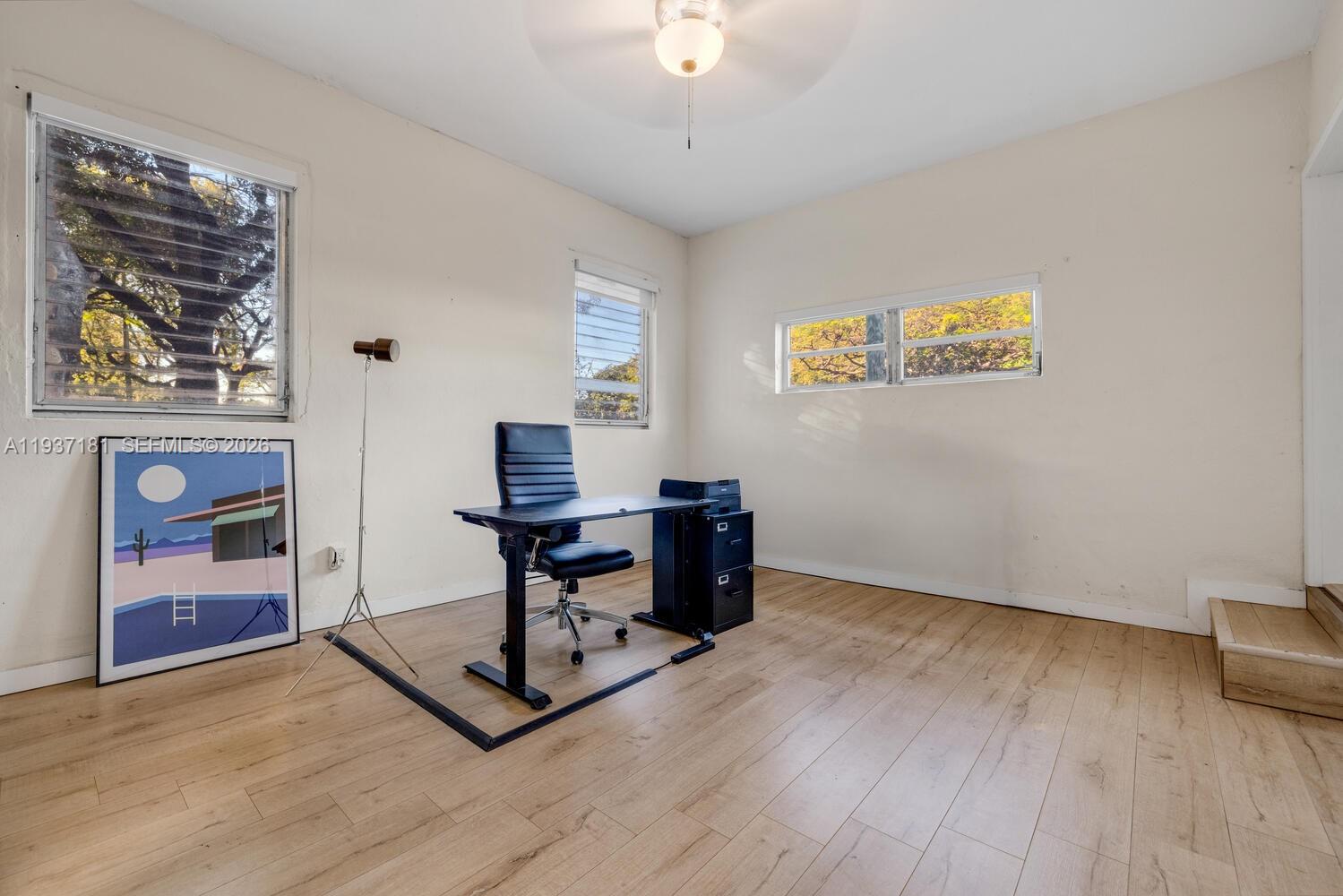 424 Northwest 53rd Street Miami, FL 33127 - Photo 16 of 20 a view of a workspace with furniture and a window