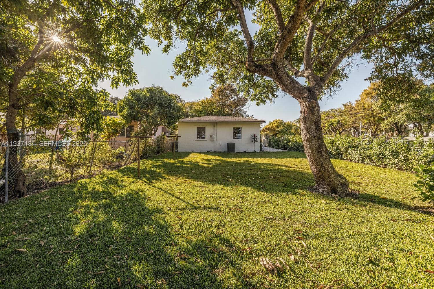 424 Northwest 53rd Street Miami, FL 33127 - Photo 2 of 20 a view of a house with backyard and tree