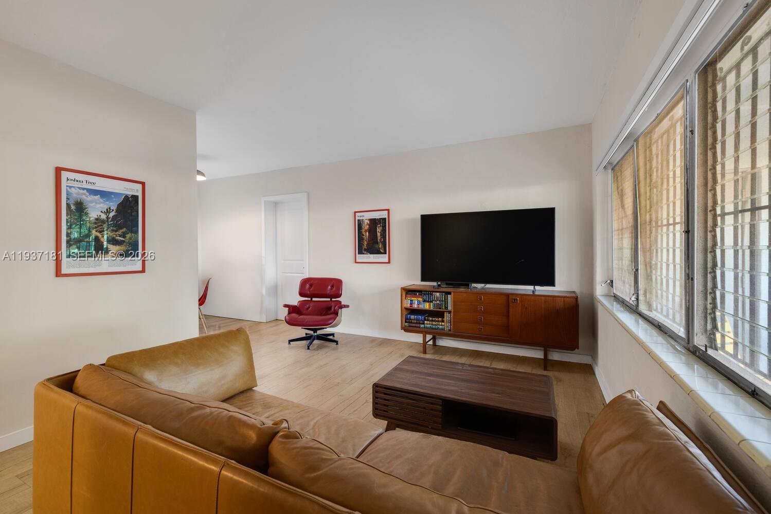 424 Northwest 53rd Street Miami, FL 33127 - Photo 8 of 20 a living room with furniture and a flat screen tv