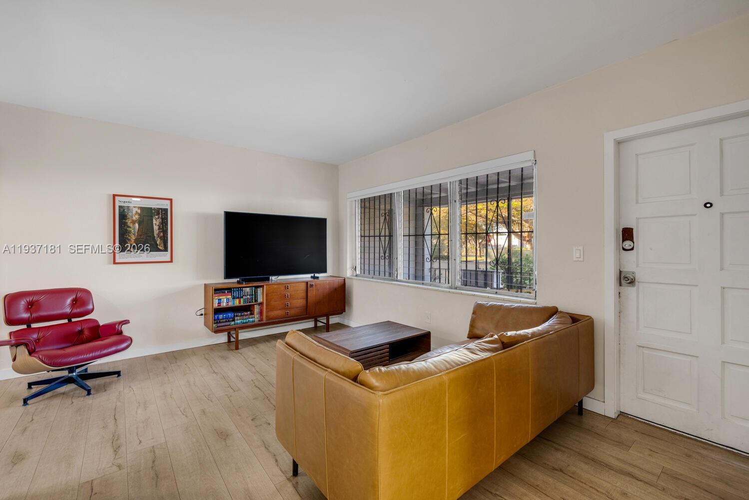 424 Northwest 53rd Street Miami, FL 33127 - Photo 9 of 20 a living room with furniture and a flat screen tv