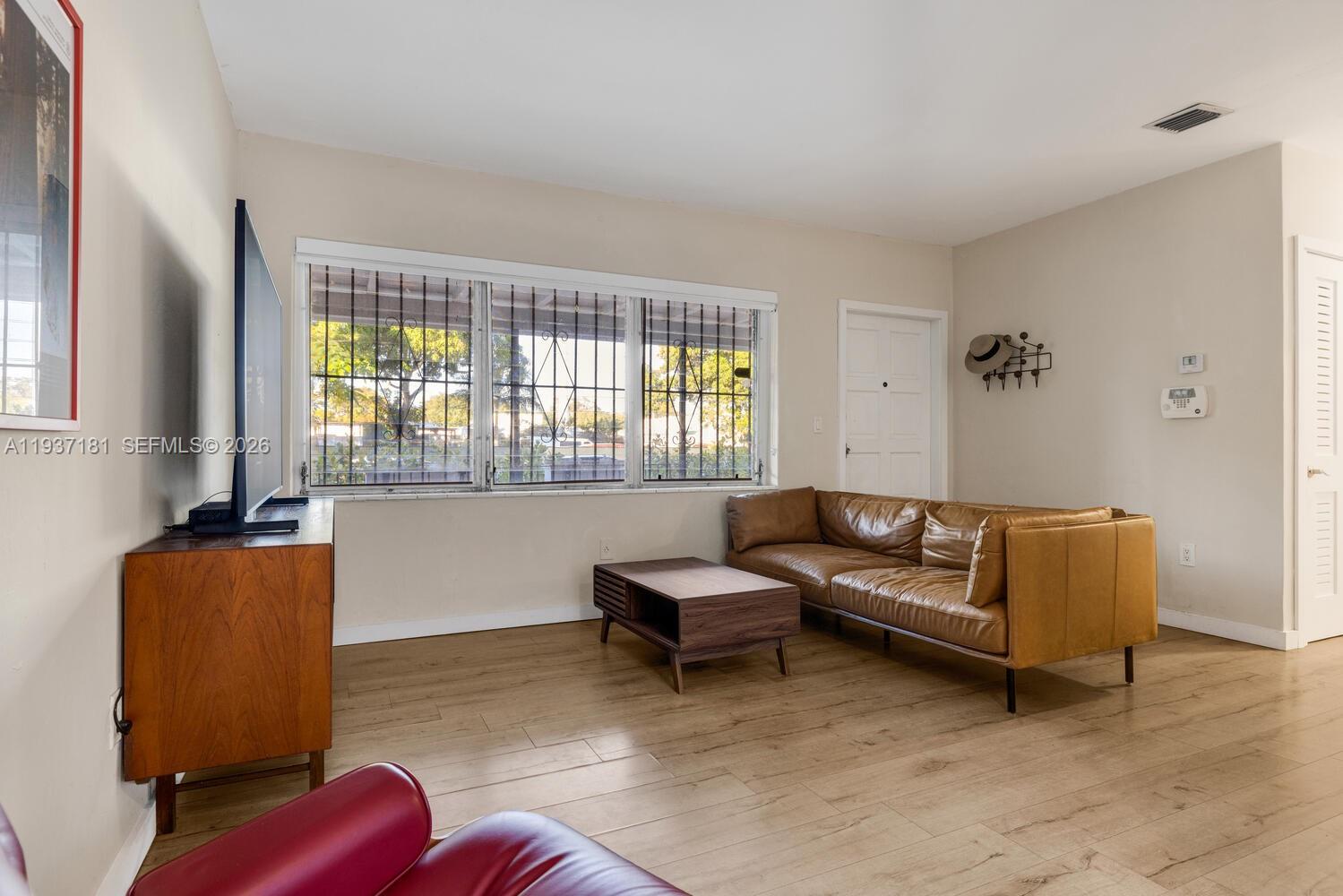 424 Northwest 53rd Street Miami, FL 33127 - Photo 10 of 20 a living room with furniture and a window