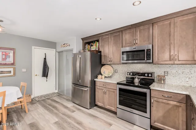 a kitchen with a refrigerator stove and microwave