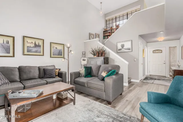a living room with furniture and a potted plant