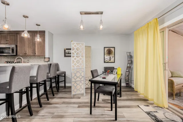 a view of a a dining room with furniture window and wooden floor