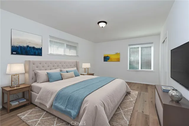 a bedroom with a bed and a flat screen tv