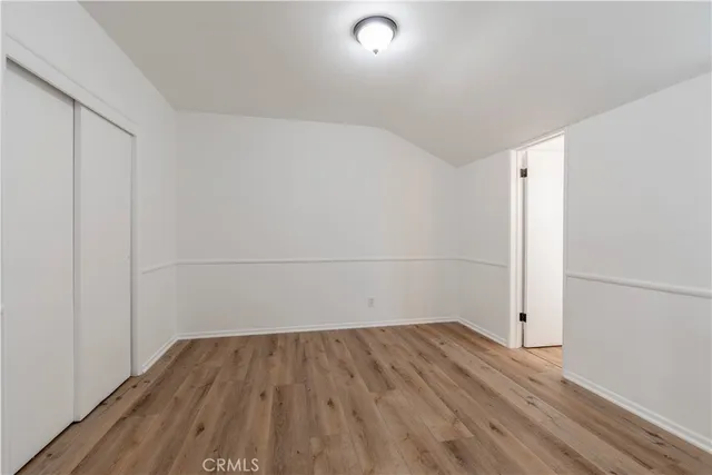 an empty room with wooden floor