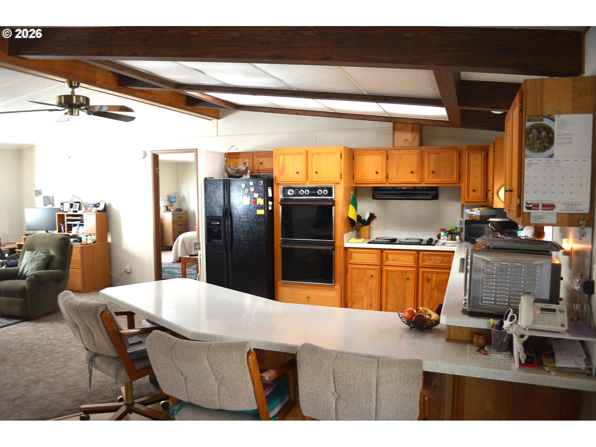 244 Kaehn Road Crescent, OR 97733 - Photo 9 of 47 a kitchen with stainless steel appliances kitchen island granite countertop a table chairs and a refrigerator