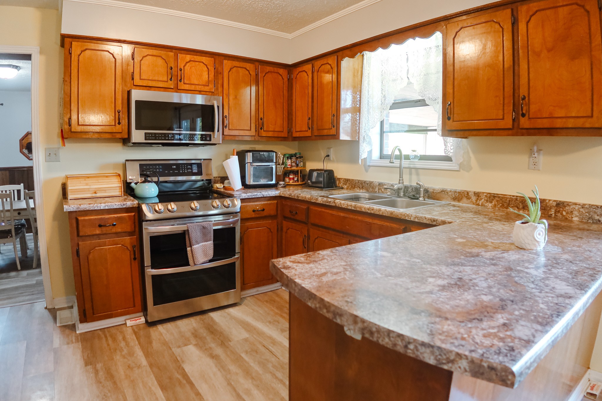 305 Highway 49 Tennessee Ridge, TN 37178 - Photo 12 of 32 a kitchen with stainless steel appliances granite countertop a stove a sink and a microwave