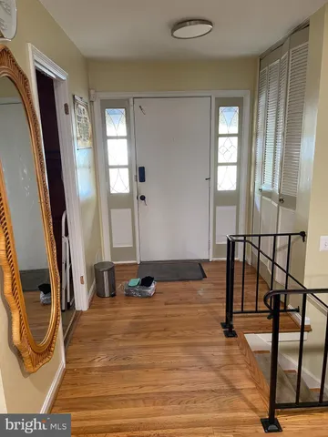 a view of entryway with wooden floor and stairs