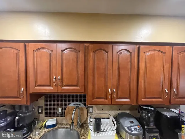 a kitchen with granite countertop cabinets and black wooden floor