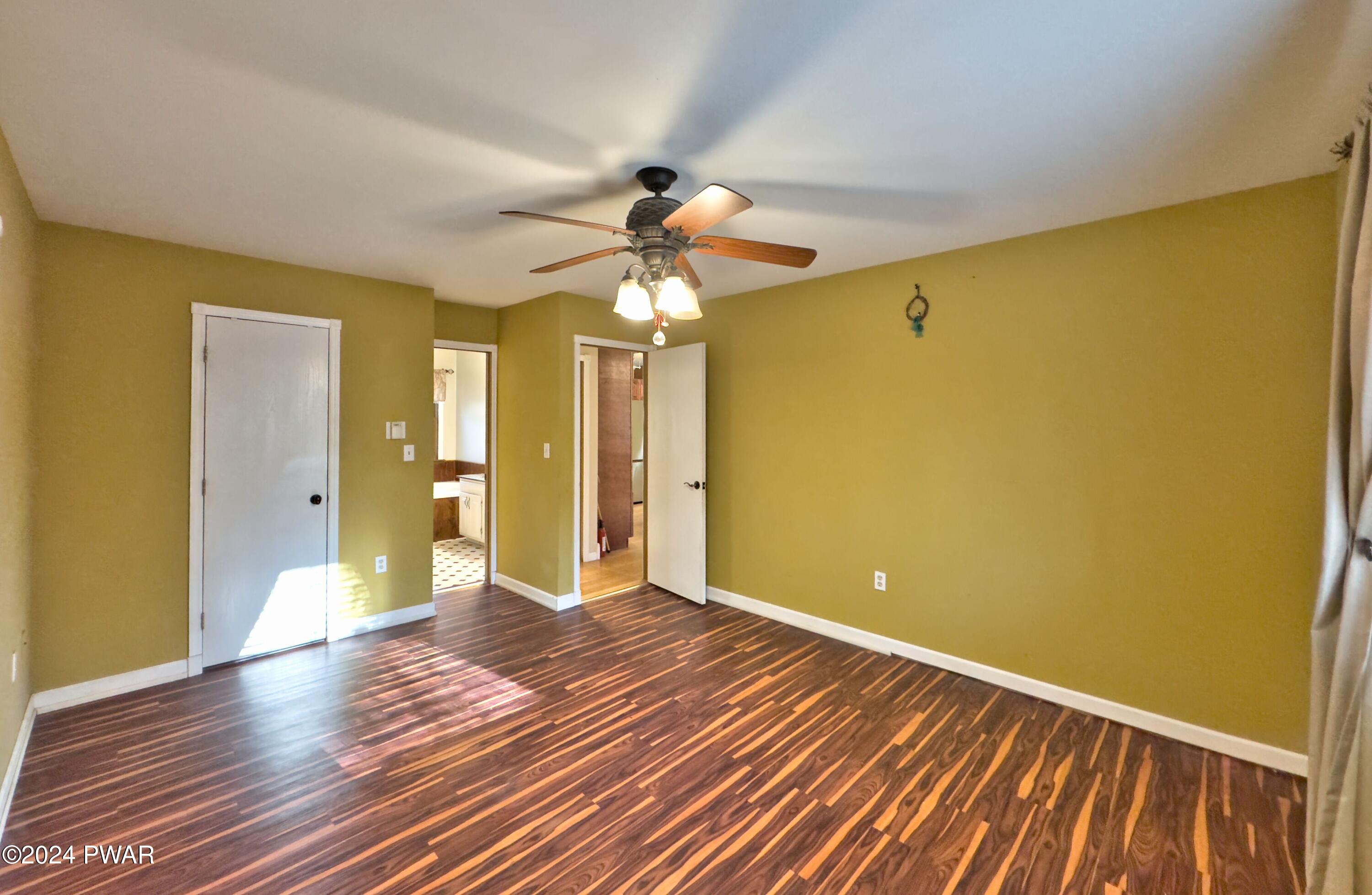 102 Maple Ridge Road Milford, PA 18337 - Photo 15 of 52 a view of an empty room with window and wooden floor