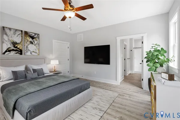 a view of bathroom with a window and a white wall