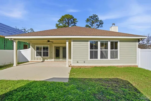 a view of a house with a yard and a garden