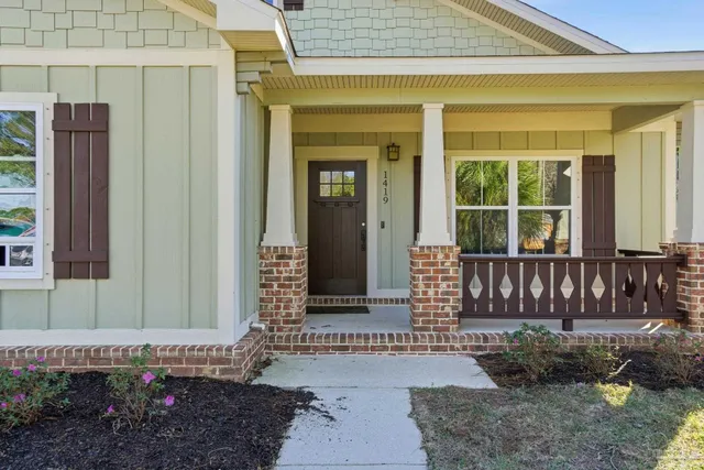 a view of a house with a small yard and wooden floor and fence