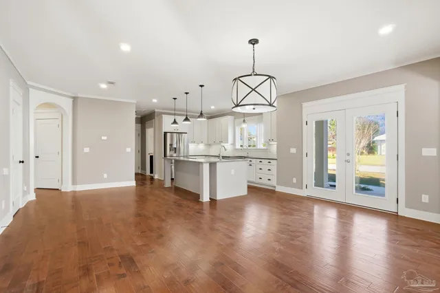 a view of a kitchen with a sink dishwasher a refrigerator and a chandelier