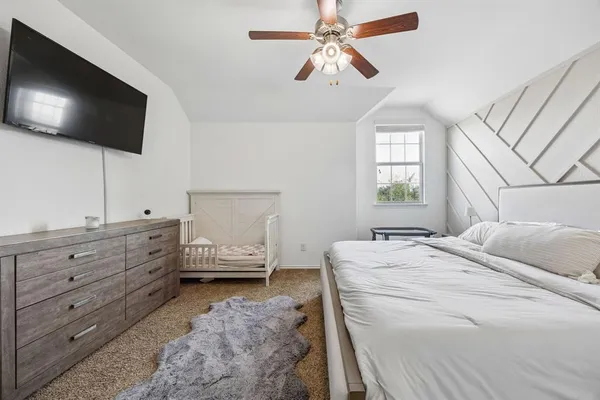 a bedroom with a bed and a flat screen tv