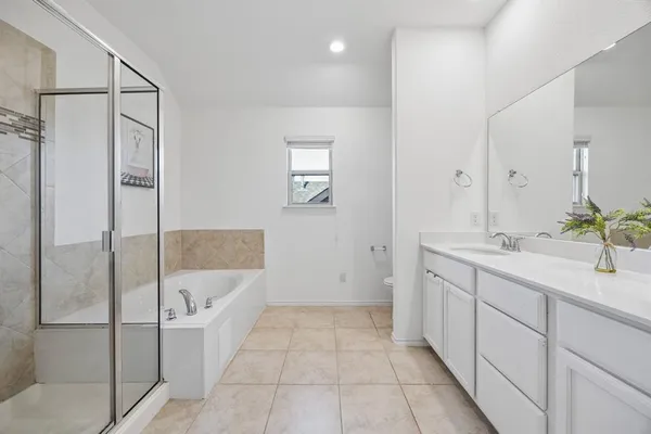a bathroom with a tub shower and sink