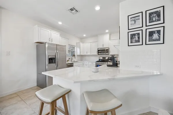 a kitchen with stainless steel appliances a refrigerator and a stove