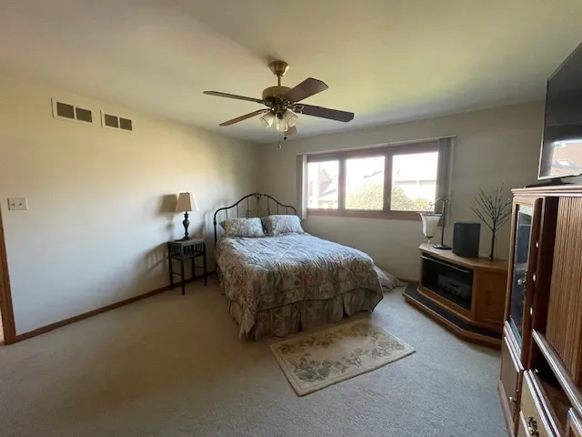 a bathroom with a sink a toilet a mirror and shower