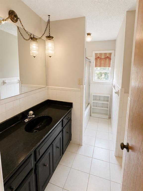 504 Aspen Road Gainesville, TX 76240 - Photo 4 of 11 a kitchen with a sink a stove and cabinets