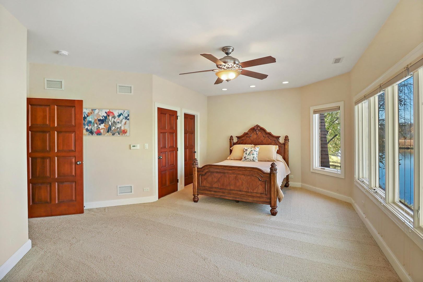 1004 Pistakee View Drive Johnsburg, IL 60051 - Photo 39 of 74 a bedroom with a large bed and a chandelier