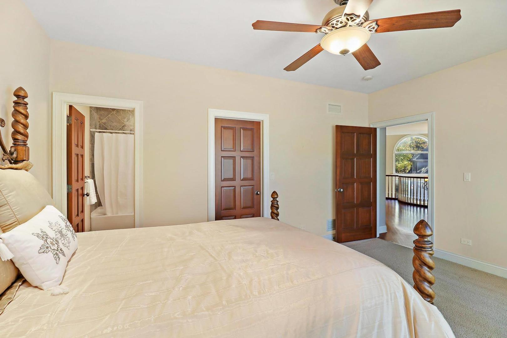 1004 Pistakee View Drive Johnsburg, IL 60051 - Photo 42 of 74 a bedroom with a large bed and a chandelier