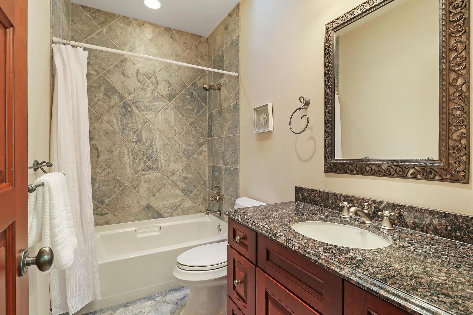 1004 Pistakee View Drive Johnsburg, IL 60051 - Photo 43 of 74 a bathroom with a granite countertop sink a toilet and shower